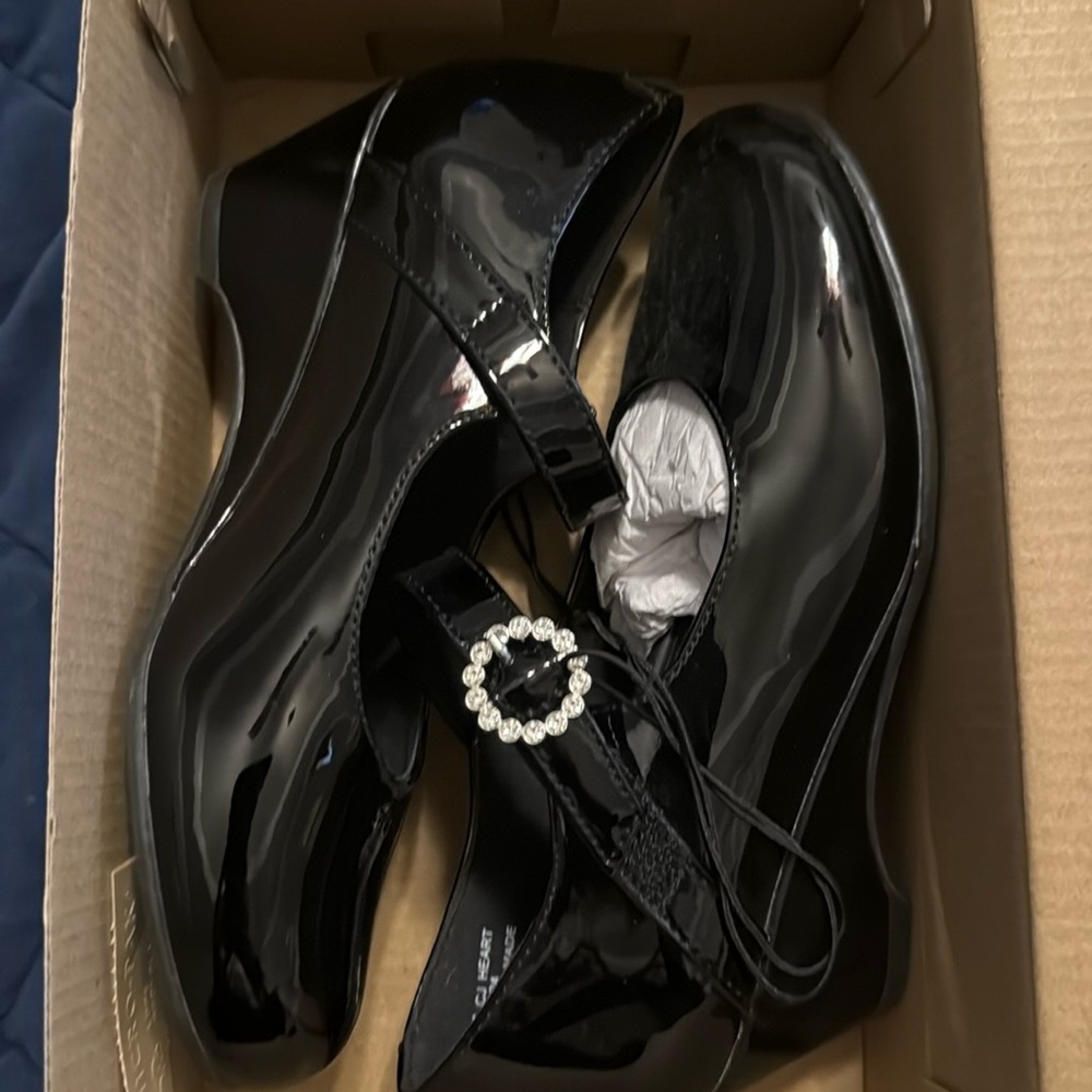 Black dress shoes with velcro strap.